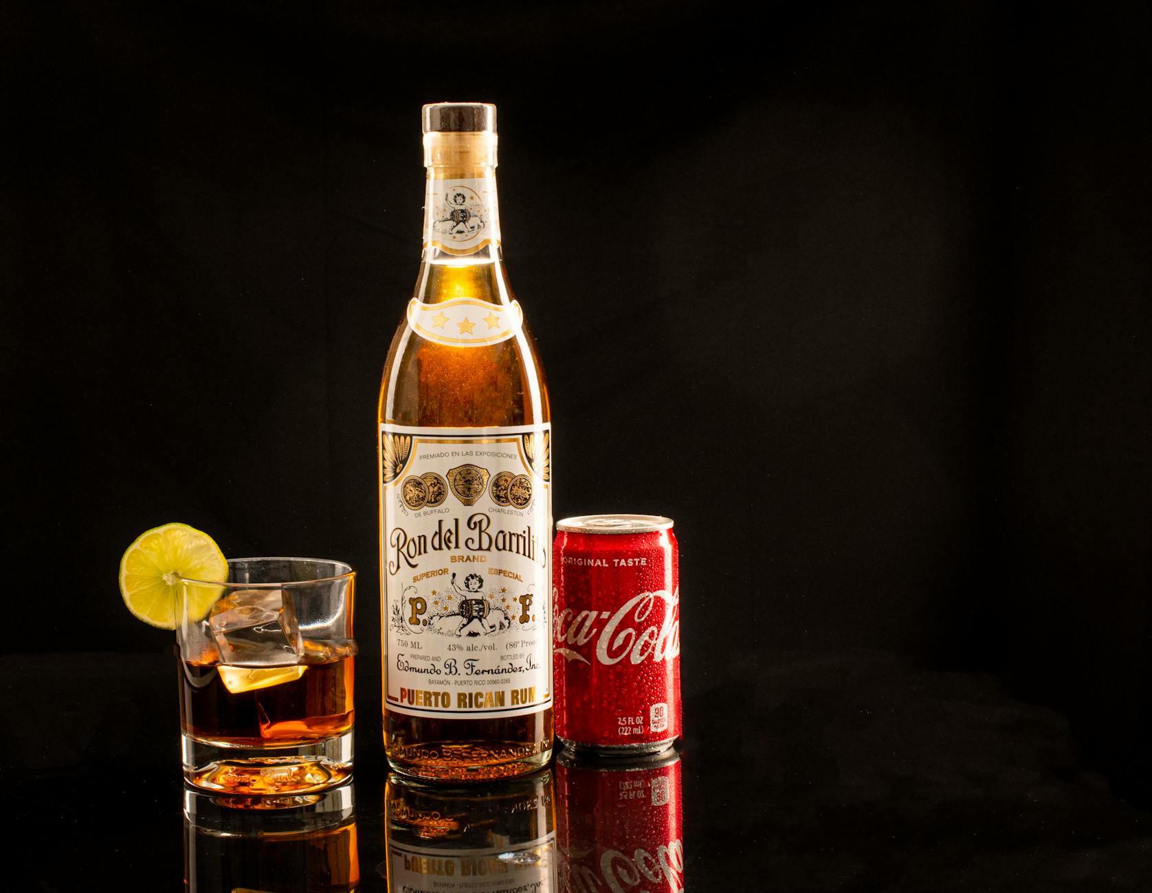 Szklanka rumu z colą i limonką na ciemnym tle